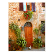 A cat seeks entrance to home in Pienza, Italy. Post Cards