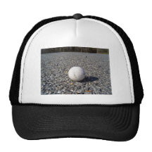 A golf Ball resting on gravel Mesh Hats