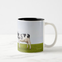 A Holstein Dairy cow with spots in the shape of Coffee Mugs