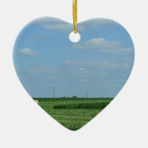a tractor cutting wheat fields and a water tower christmas ornament