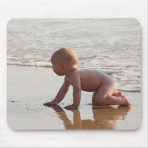 Baby playing in the sand on the beach mouse pads