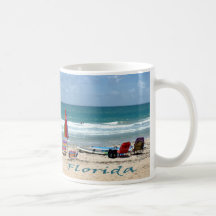 beach chairs surfboards umbrellas sand ocean coffee mug