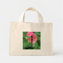 Blue dragonfly on pink flower green background tote bags
