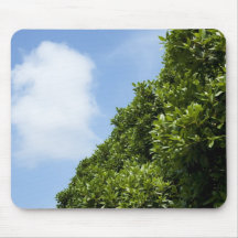 Blue sky with white cloud and green foliage mousepads