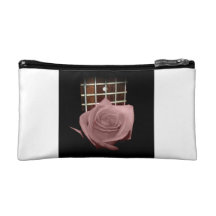 Brownish pink single rose against fretboard makeup bag