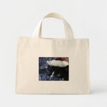 Cat ready to pounce behind blue tinsel, faded tint tote bag