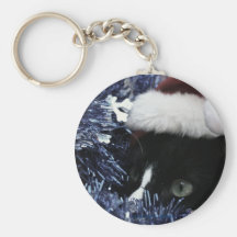 Cat ready to pounce behind blue tinsel, faded tint keychain