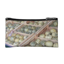 Charentais melons displayed in grocery store cosmetic bags
