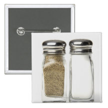 Close-up of a salt and a pepper shaker buttons