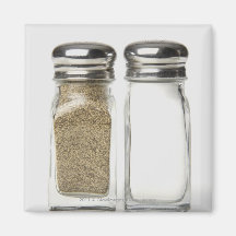 Close-up of a salt and a pepper shaker fridge magnet