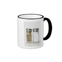 Close-up of a salt and a pepper shaker mugs
