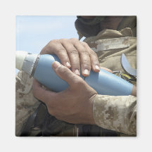 Close-up view of a soldier cradling a munition fridge magnets