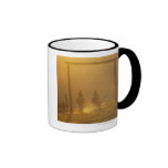 Cowboys riding through gate at dusk coffee mug