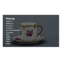Cup and saucer with colourful flowers on it. business card