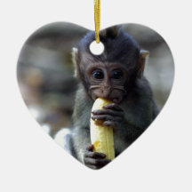 Cute baby macaque monkey eating banana christmas tree ornaments