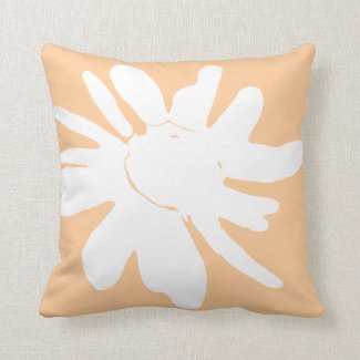 daisy print in white on peach background cushion