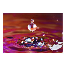 Drop of Water Falling into Rainbow Coloured Liquid Photo