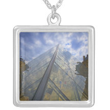 France, Paris. Clouds reflect off the Louvre Pendant