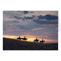 Horseback riders at sunset 2 greeting card
