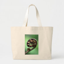 Koru unfurling fern frond tote bags