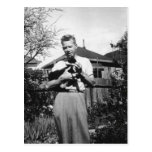 man holding kitty post cards