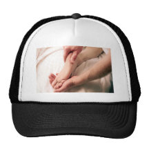 Man Massaging Male Foot Trucker Hat