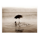 Man reading under umbrella in the Dead Sea Postcard
