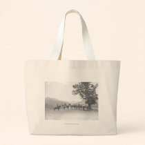 Men with packhorses looking over a hill bags