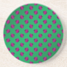 Pink shamrocks on green background coasters