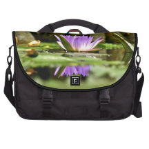 PURPLE WATER LILY REFLECTING IN A POND COMMUTER BAGS