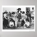 Seven rodeo cowgirls jokingly posing with a donkey print