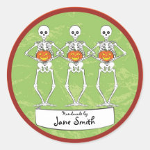 Skeletons holding pumpkins round stickers