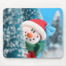 Snowman hiding or peeking from behind a tree mousepad