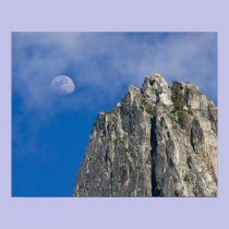 The moon rises and shines through the clouds posters