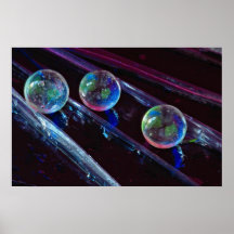 Three glass marbles rolling on smooth surface posters