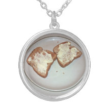 Toasted bread with butter in a plate necklaces