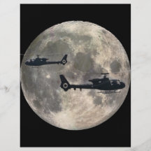 two helicopters silhouetted by a full moon flyer
