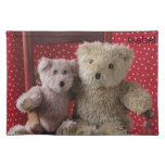 two teddy bears in a red chair place mat