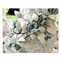 White lacy wedding cake with green butterfies photograph