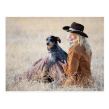 Woman and dog sitting in field post cards