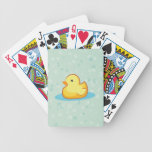 Yellow duck with floating bubbles around playing cards