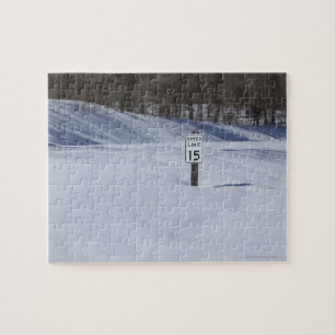 15 mph sign buried in snow jigsaw puzzle