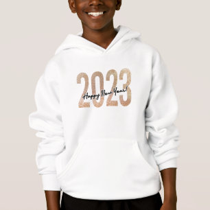 2023 happy new year with golden glittery text.