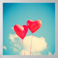 2 Bright Red Heart Shaped balloons Floating Upward