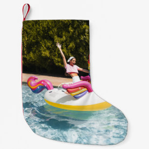 2 children riding on white and red inflatable boat small christmas stocking