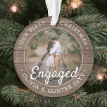 2 Photo First Christmas Engaged Rustic Faux Wood Ornament<br><div class="desc">Celebrate the joyful 1st holiday of your engagement with a custom 2 photo "Our First Christmas Engaged" round faux wood acrylic ornament. All wording and images on this template are simple to personalise and can be different or the same on front and back. (IMAGE & TEXT DESIGN TIPS: 1) To...</div>