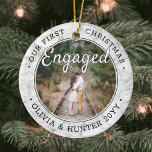 2 Photo Our First Christmas Engaged Faux Marble Ceramic Ornament<br><div class="desc">Celebrate the joyful 1st holiday of your engagement with a custom 2 photo "Our First Christmas Engaged" round faux marble ceramic ornament. All text and images on this template are simple to personalise. (IMAGE & TEXT DESIGN TIPS: 1) To adjust position of wording, add spaces at beginning or end. 2)...</div>
