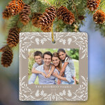 2 Photos Family Winter Greenery Tan Christmas Ceramic Ornament<br><div class="desc">This light tan Christmas ornament showcases an elegant white winter greenery illustration that frames the horizontal photo. The design offers space for 2 of your favourite pictures,  one on the front and another on the back. Personalise this lovely keepsake ornament with your family name and the year.</div>