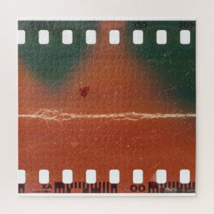 35mm filmstrip start, cool scratches. jigsaw puzzle