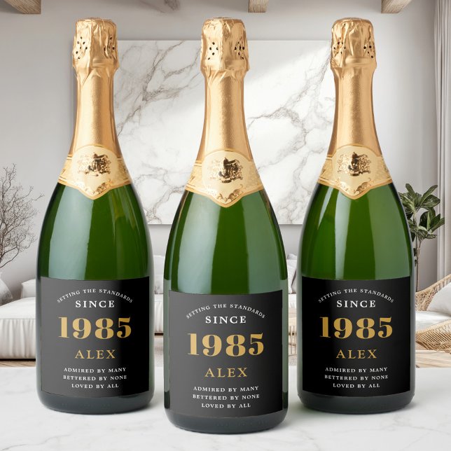 40th Birthday Name 1985 Black Gold Elegant Chic Sparkling Wine Label (Custom 40th birthday sparkling wine labels on 3 bottles in a modern room)